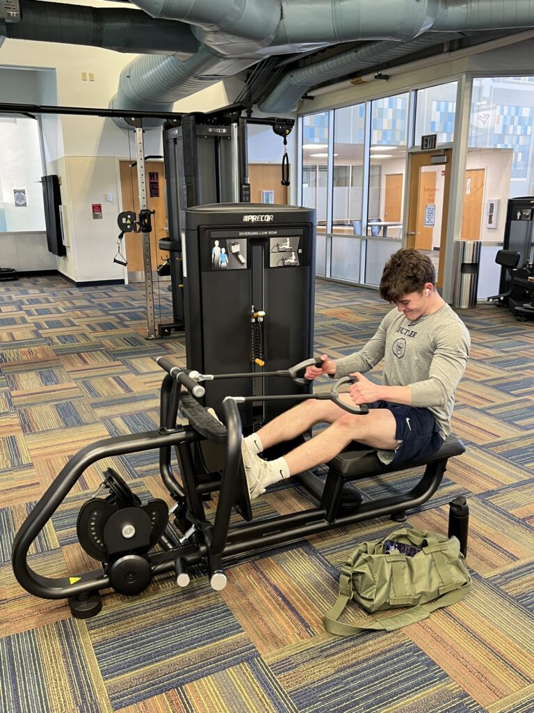 This is a photo of a man on a fitness machine in the recreation center.