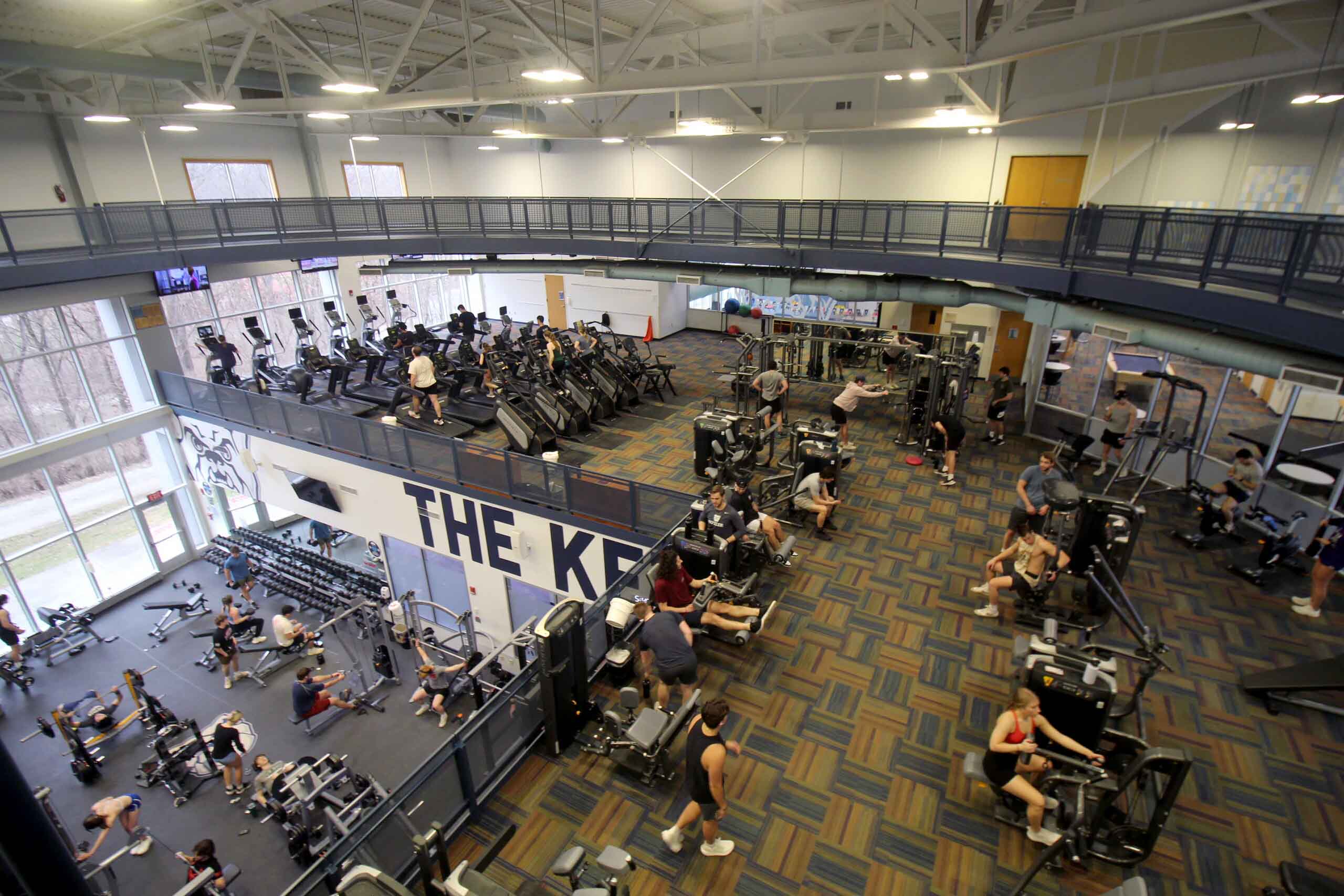 Fitness area users work out on exercise equipment on multiple levels of the Health and Recreation Complex.