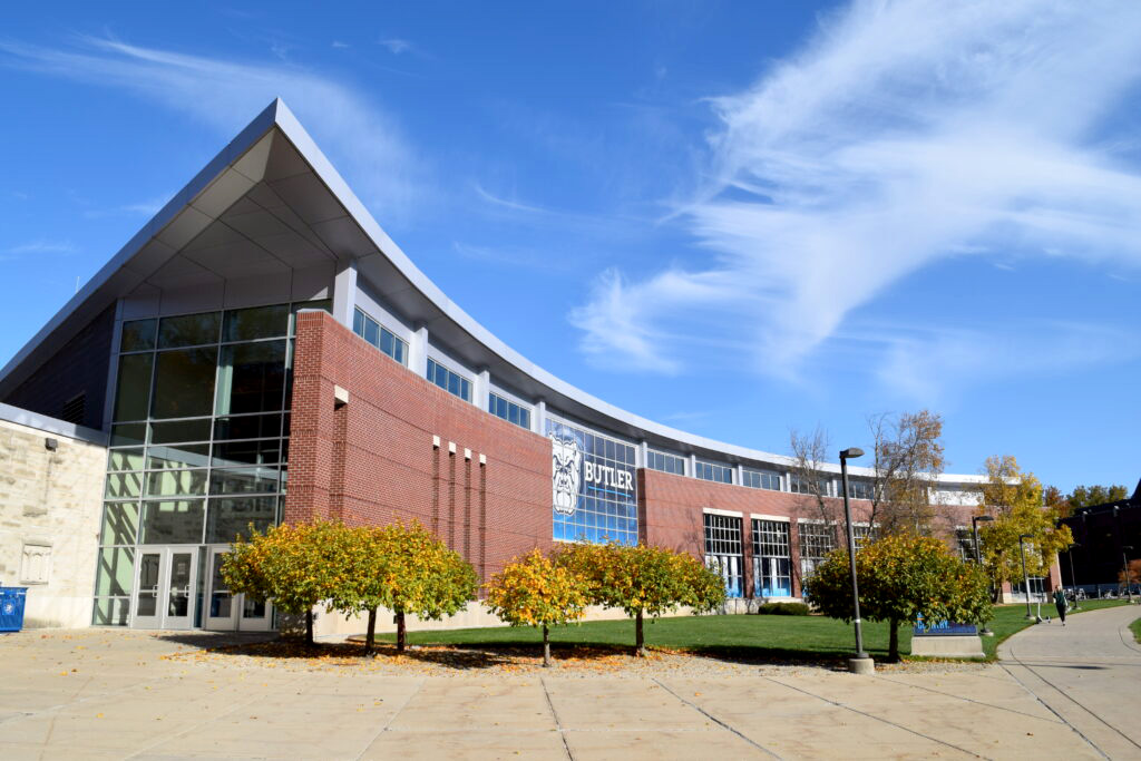 Health and Recreation Complex brick facade and side entrance doors with ornamental tree landscaping near the entrance walkway.