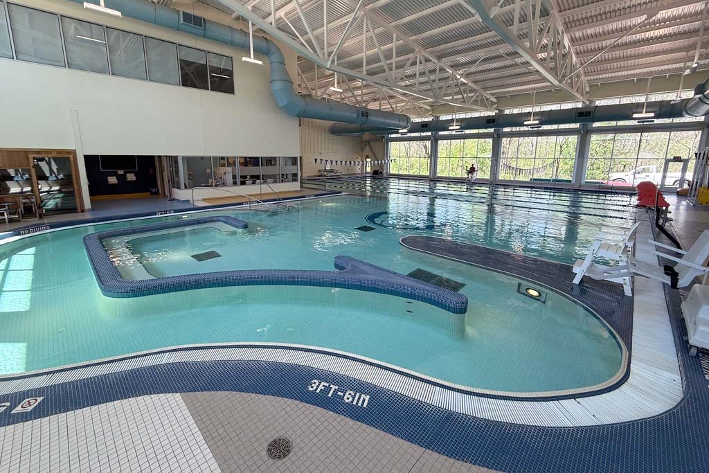 Indoor lazy river pool and a leisure pool and swimming lanes in the background.
