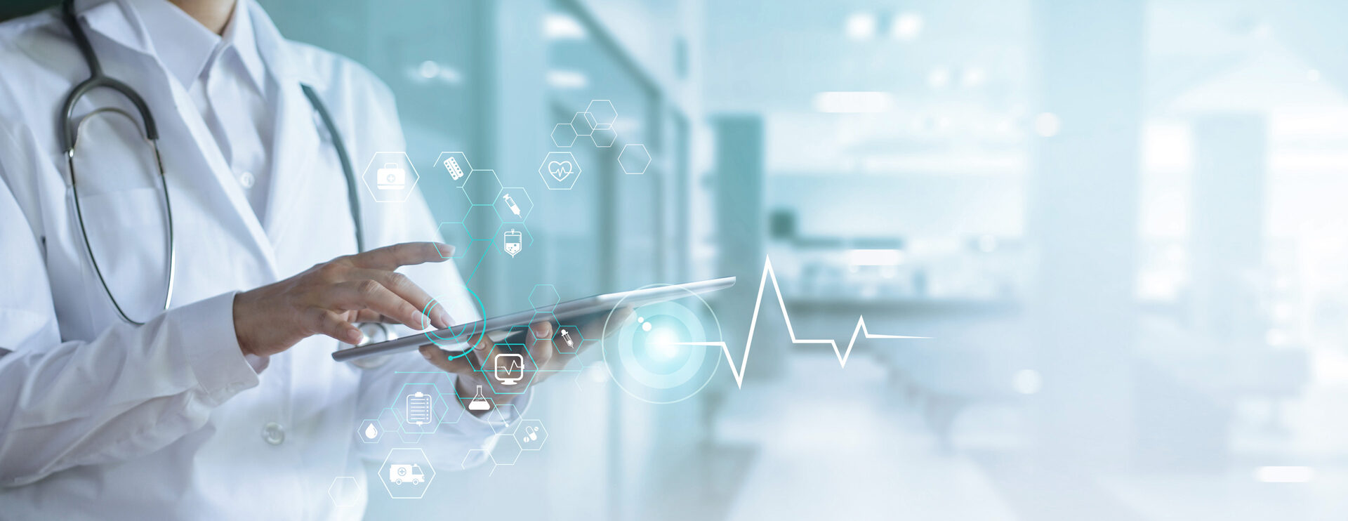 A closeup of a tablet being held by a medical doctor. The doctor's face is not visible and the doctor is touching the tablet with one finger. Graphics with medicine-related icons are superimposed over the tablet where the doctor is touching the screen.