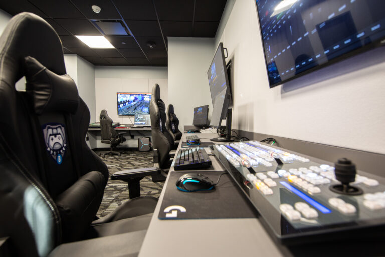 side view of gamers chairs, keyboards and screens
