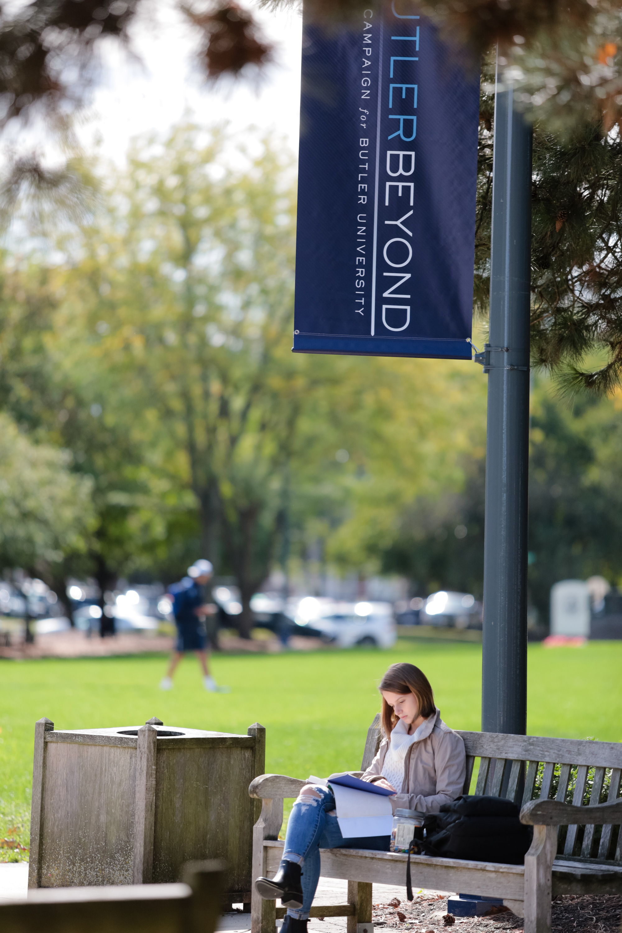 student studying on a bench outside
