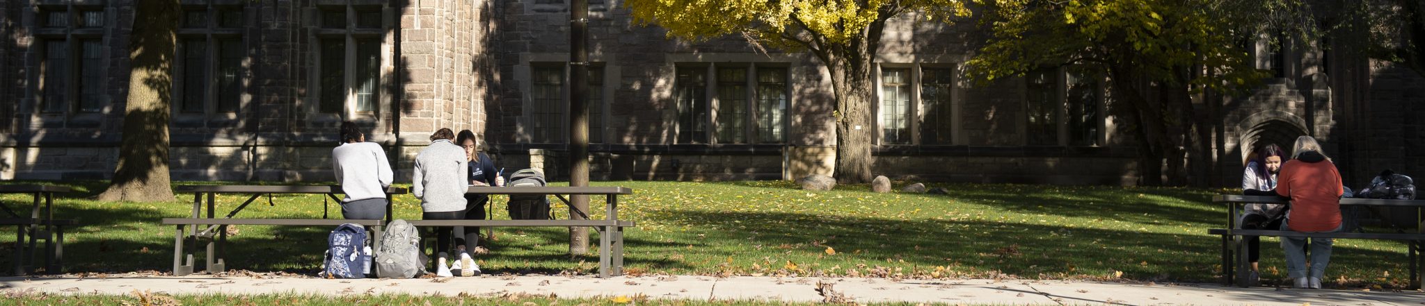 students at picnic tables outside of Jordan Hall