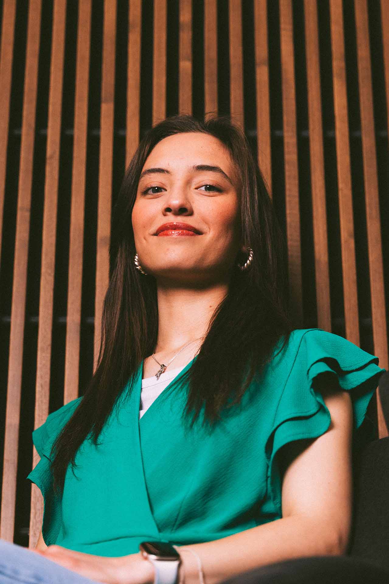 Portrait of Juanita Rojas looking down with confidence.