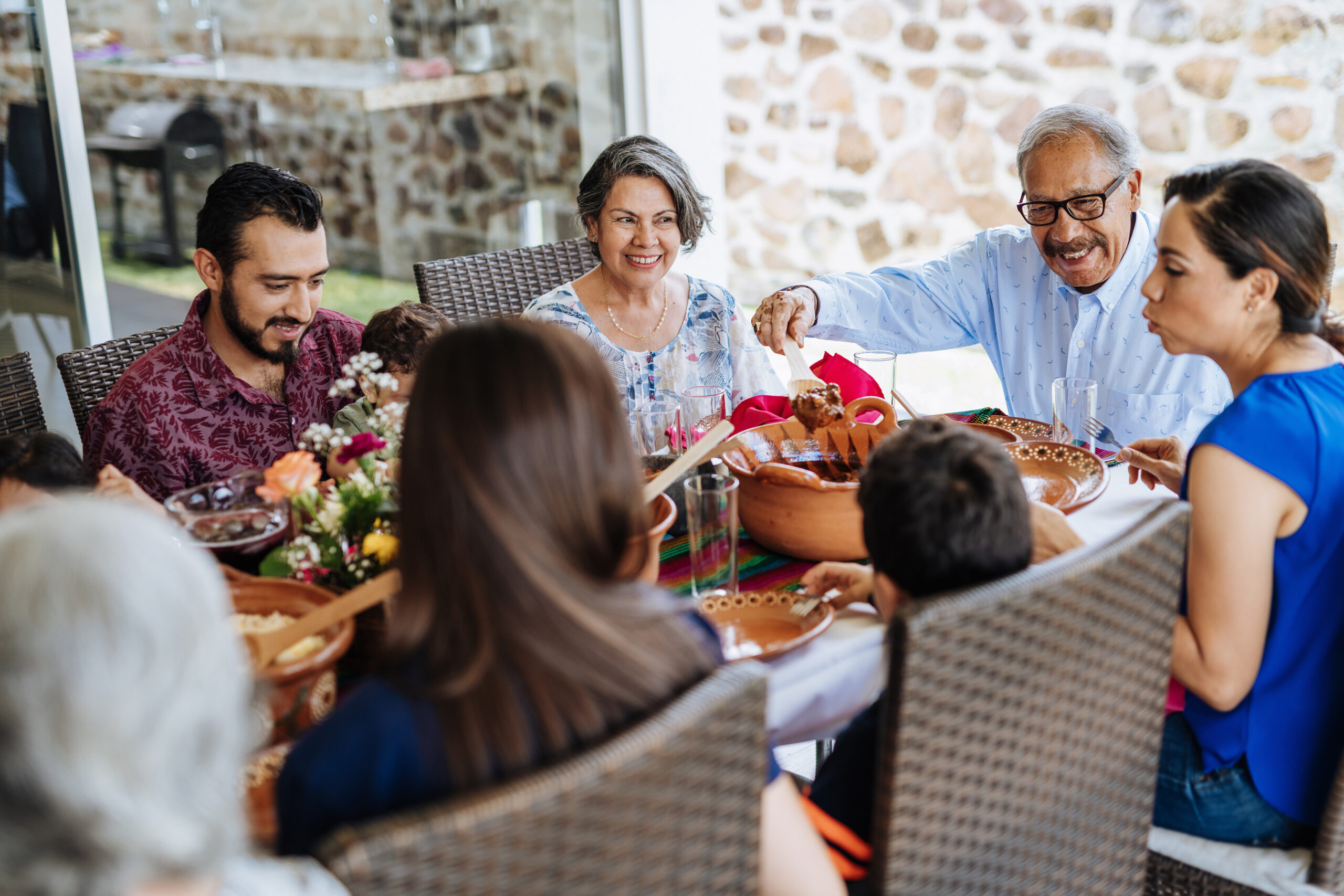 Image of a family around a dinner table together