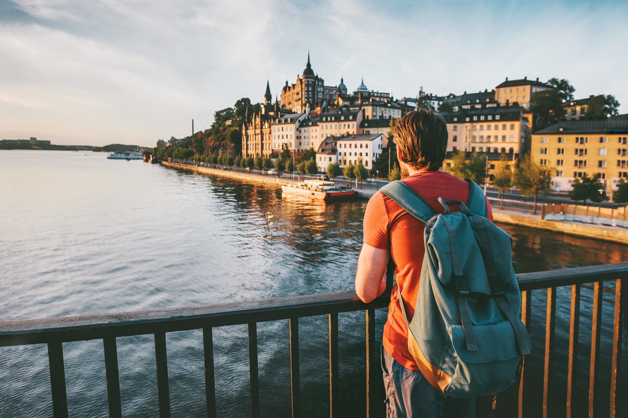 Image of a student traveling and standing next to a river