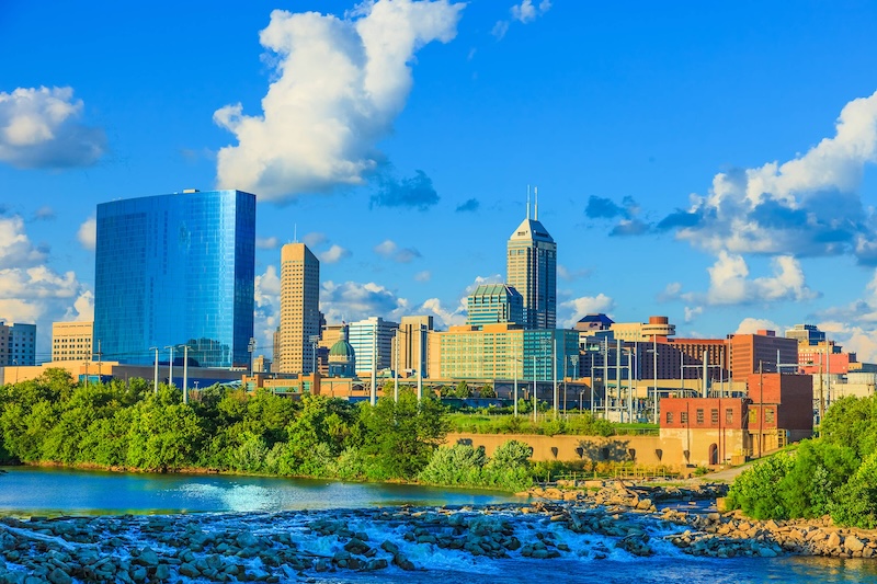 Skyline of Downtown Indianapolis, Indiana, with a river in the foreground.