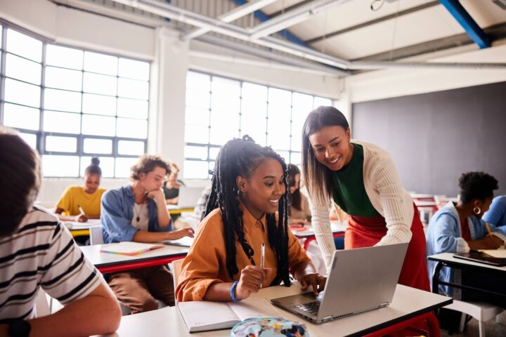 Image of students in a classroom with a teacher
