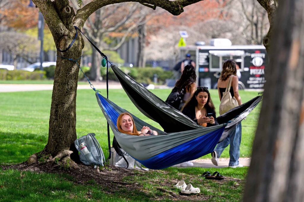 Students lounge in hammocks in shady spot on the Butler campus mall.