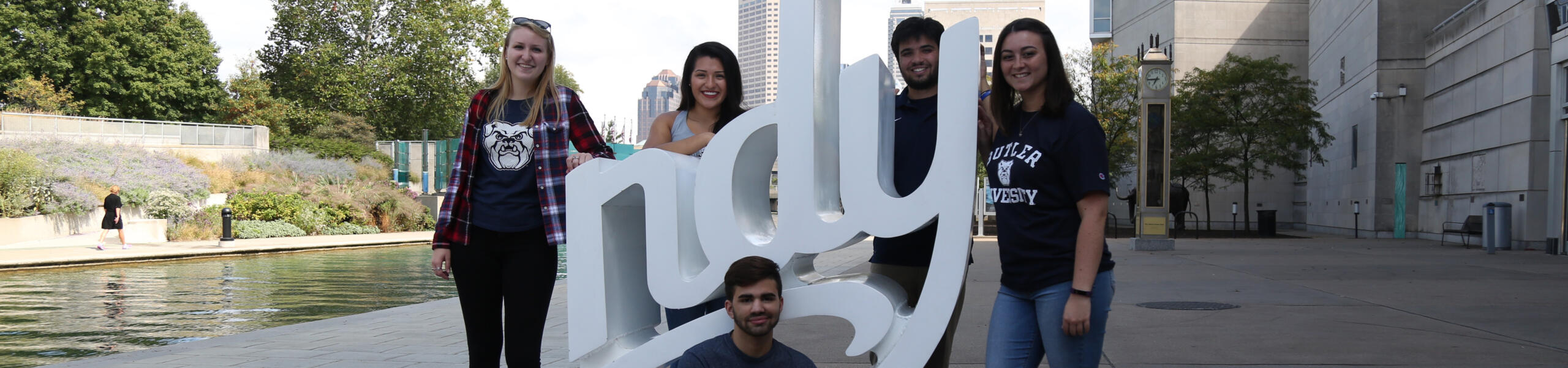 Butler students gather at an Indy sign near a canal