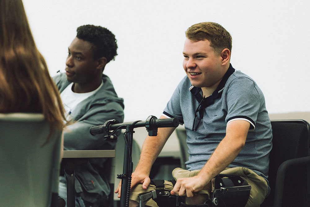 Students laugh in a classroom.