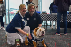 Alumni pose with Butler Blue IV at the annual Bulldogs at the Brickyard event