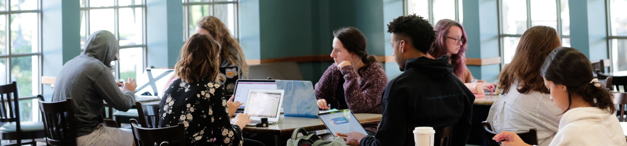 Students with laptops studying in the Starbucks on Butler's campus.